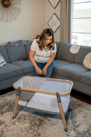 Mom looking at baby that's resting in the Boppy Bassinet