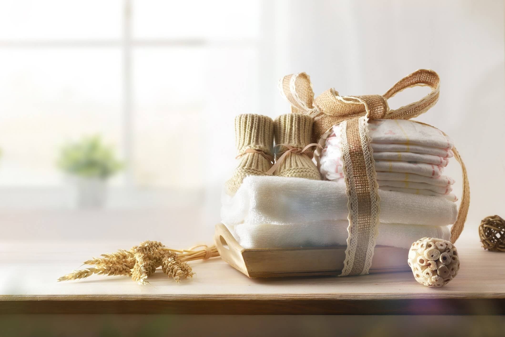 baby shoes diapers and blankets wrapped in gift