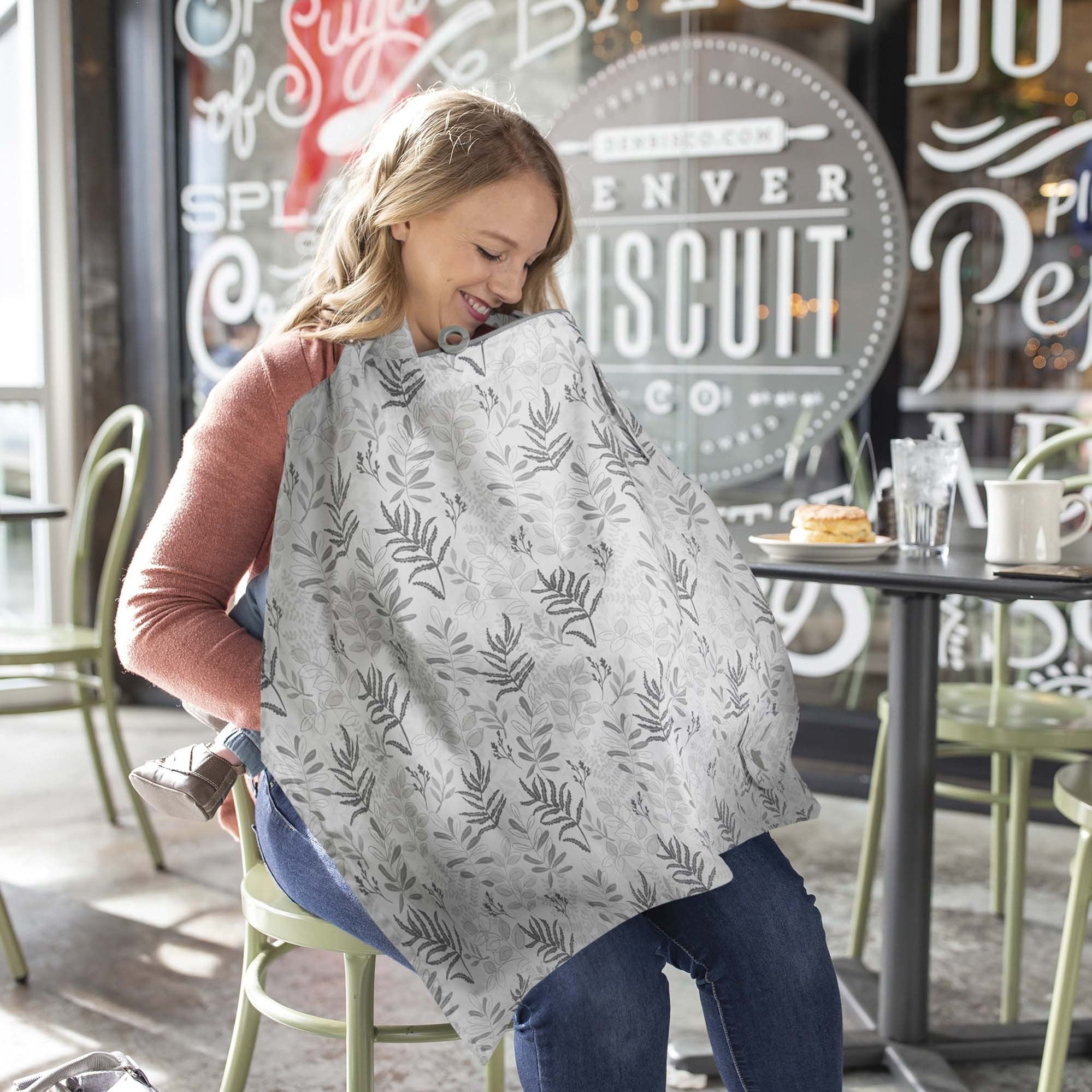 woman nursing in public with nursing cover