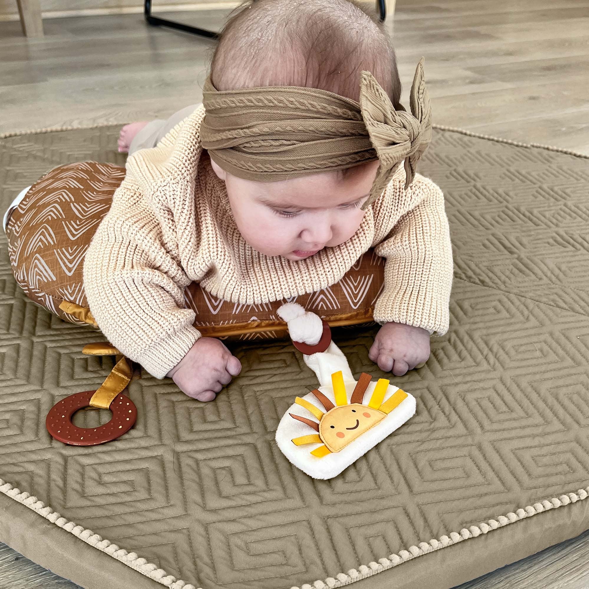 baby playing on play mat