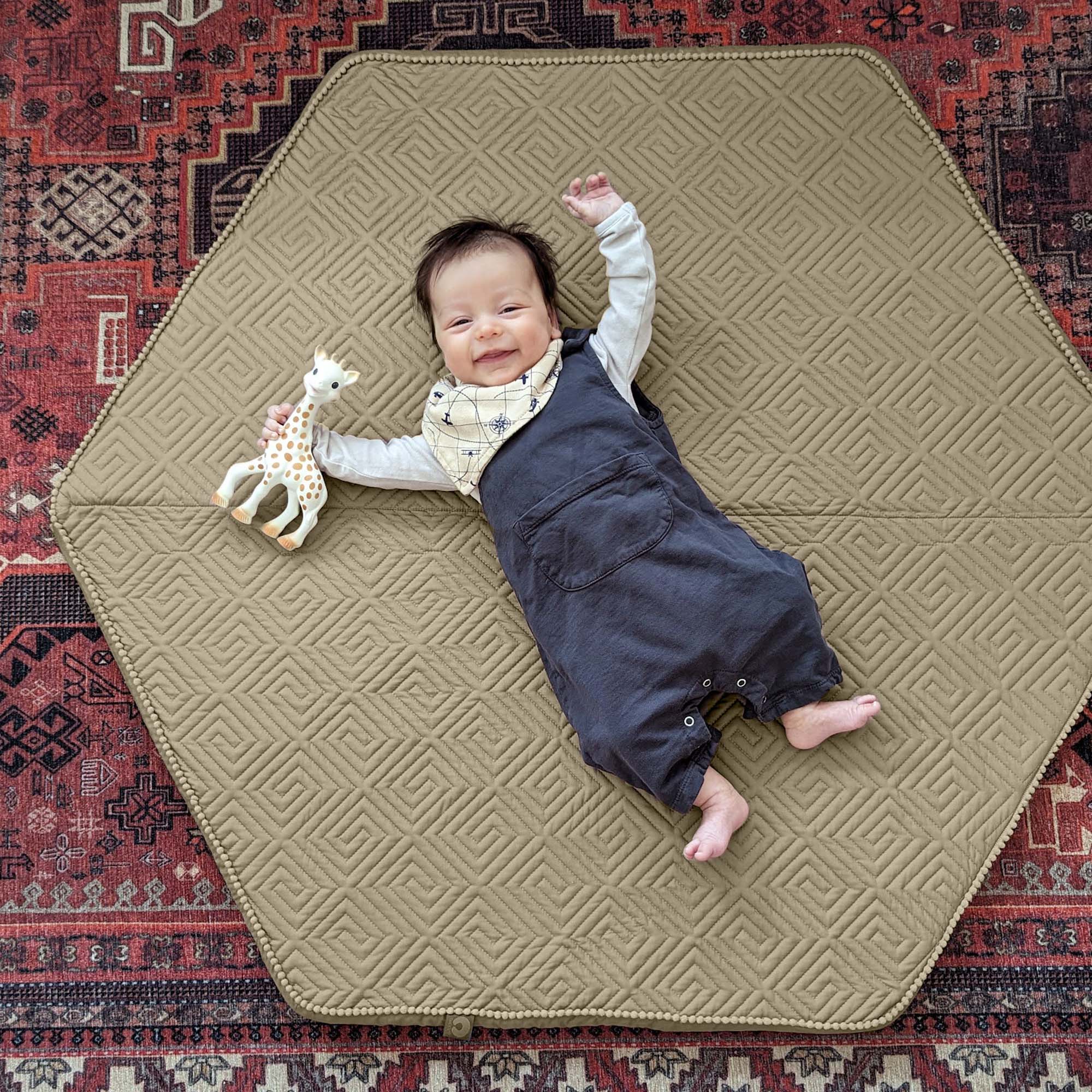 baby laying on play mat