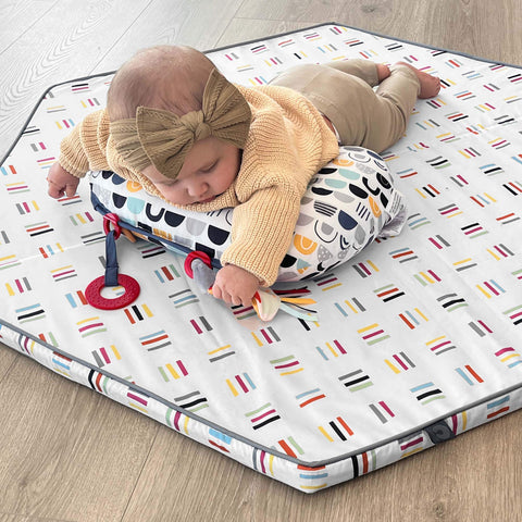 baby on a playmat doing tummy time